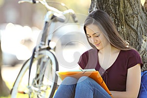 Student learning memorizing notes outdoors photo
