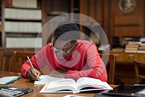 Student in library studying for exam