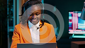 Student listening to music while she writes her essays at home