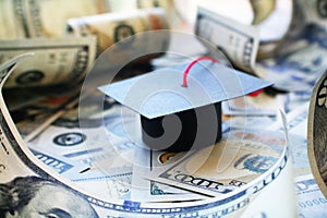 Student Loan Debt With Graduation Cap On Money Barrowed photo