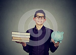 Student loan. Man with pile of books and piggy bank