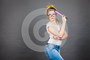 Woman holding big oversized pencil thinking about something