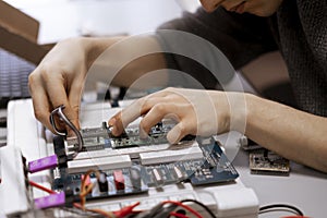 a student making measurement and costruct the circuit board with engineer equipment, studying process