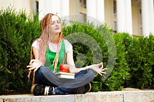 Student meditating outdoors