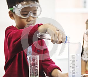 Student Mixing Solution in Science Experiment class