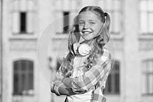 Student. Modern education. Cheerful teen listening music. Stylish schoolgirl going to school. Little girl with backpack