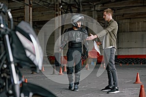 Student motorcyclist and instructor discussing rout of future exam race photo