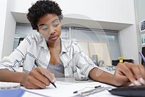 student notes on notebook while learning online study