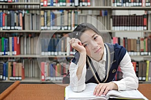 Student with open textbook deep in thought