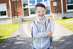 Student outside school standing smiling