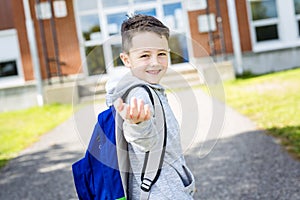 Student outside school standing smiling