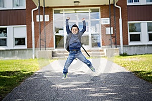 Student outside school standing smiling