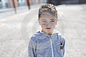 Student outside school standing smiling