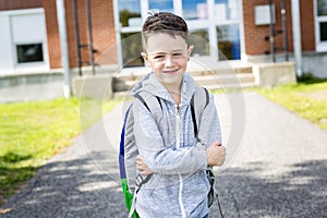 Student outside school standing smiling