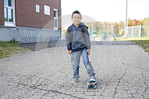 Student outside school standing smiling