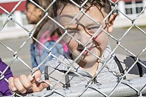 Student outside school standing smiling