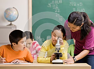 Student peering through microscope