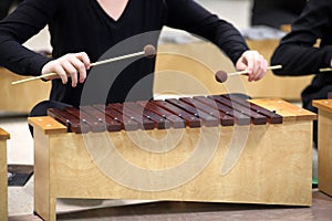 Student playing Diatonic Xylophone with mallets photo