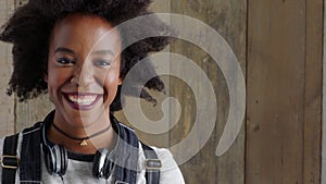 Student with positive attitude smiling with joy. Portrait of a modern black woman laughing with copyspace. Trendy and