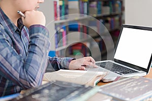 Student preparing exam and learning lessons in school library,