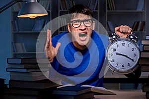 The student preparing for exams late at night in library