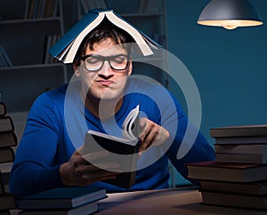 Student preparing for exams late at night in library