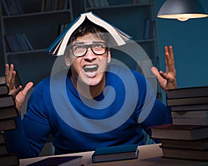 Student preparing for exams late at night in library