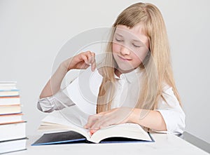 A student pulls a page from a book