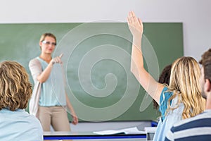 Student raising hand in classroom photo