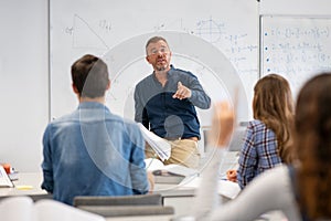 Student raising hand in classroom at the high school