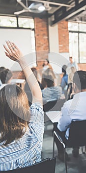 Student raising hand during lecture or seminar