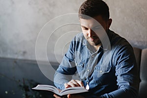 Student read book in cafe. Study and education. Young man spend time in cafe