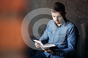 Student read book in cafe. Study and education. Young man spend time in cafe