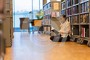Student reading book in library