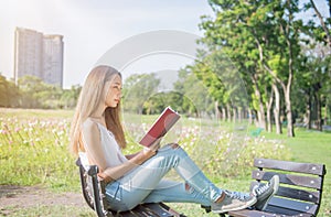 Student reading a book in the park