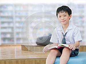 Student reading book in school library