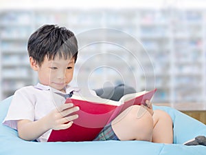 Student reading book in school library