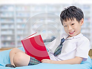 Student reading book in school library
