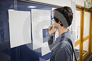 Student reading notice board