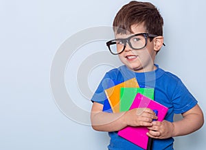 Student ready for school. Children`s Stationery for school. Kid with notebook and pen in hands.