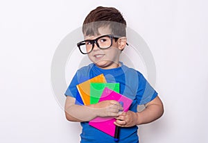 Student ready for school. Children`s Stationery for school. Kid with notebook and pen in hands.