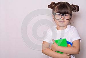 Student ready for school. Children`s Stationery for school. Kid with notebook and pen in hands.