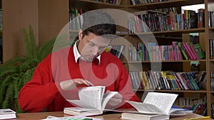 Student researching with a book in a library, slow