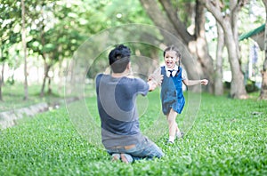 Student running into father hands to hug