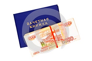 Student`s exam book and stack of russian rubles isolated on white