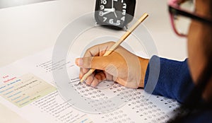 Student`s hand taking English test in class