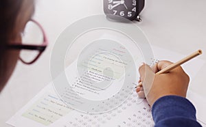 Student`s hand taking English test in class