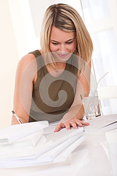 Student series - Young blond woman writing