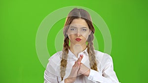 Student shows a fist, she is angry. Green screen