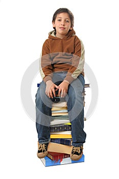 Student sitting on a pile of books